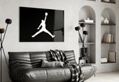Air Jordan glass wall art styled above a console in a sneaker closet
