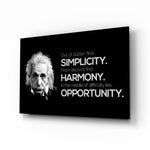 Einstein glass wall art displayed above a walnut desk in a contemporary office with rattan armchair and brass picture light