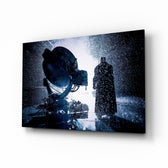 Batman Call glass wall art displayed above a black leather sectional in a moody home theater with brass arc lamp and reclaimed-wood console
