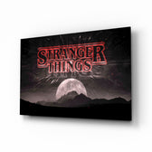 Stranger Things glass wall art displayed above a velvet sofa in a moody teen lounge with neon LED strip and matte-black coffee table