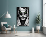 Joker glass wall art styled above a desk in an office