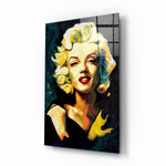Marilyn Monroe glass wall art displayed above a walnut headboard in a serene bedroom with linen drapes and a brass lamp
