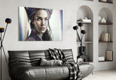 Girl with a Tattoo glass wall art styled above a sideboard in a living room