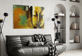 Buddha glass wall art styled above a console in a hallway