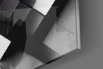 Cubic artwork anchoring a wall with bold monochrome palette