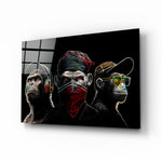 3 Wise Monkeys Neon Lines glass wall art displayed above a black desk in a moody gaming room with neon LED strips