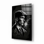Thomas Shelby glass wall art displayed above a walnut desk in a moody home office with brass sconces