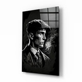 Thomas Shelby glass wall art displayed above a walnut desk in a moody home office with brass sconces