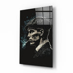 Thomas Shelby glass wall art displayed above a leather chesterfield in a moody man cave with brass sconces