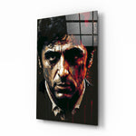 Al Pacino glass wall art displayed above a leather chesterfield in a moody man cave with brass sconces