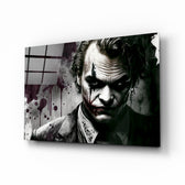 Joker glass wall art displayed above a leather sofa in a moody man cave with brass sconces