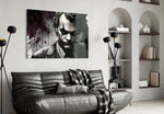 Joker glass wall art styled above a console in a study