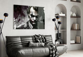 Joker glass wall art styled above a console in a study