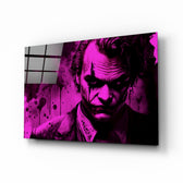 Joker glass wall art displayed above a leather sofa in a contemporary man cave with magenta LED accents
