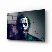 Joker glass wall art displayed above a leather sofa in a moody man cave with brass sconces