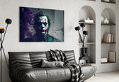 Joker glass wall art styled above a console in a study
