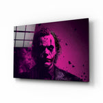 Joker glass wall art displayed above a leather sofa in a contemporary man cave with magenta LED accents