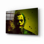 Joker glass wall art displayed above a leather sofa in a moody man cave with brass sconces