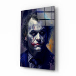 Joker glass wall art displayed above a leather sofa in a moody man cave with brass sconces