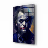 Joker glass wall art displayed above a leather sofa in a moody man cave with brass sconces