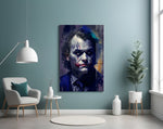 Joker glass wall art styled above a console in a study