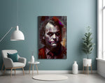 Joker glass wall art styled above a console in a study