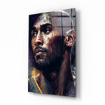 Kobe Bryant glass wall art displayed above a leather sofa in a moody man cave with brass sconces