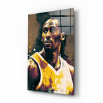 Kobe Bryant glass wall art displayed above a leather sofa in a moody man cave with brass sconces