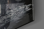Lone spaceman artwork anchoring a wall with onyx-and-ember palette