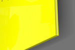 Typographic artwork anchoring a desk wall with black-on-lemon palette