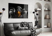 3 Wise Monkeys glass wall art styled above a console in a study