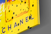 Luxury-icon artwork anchoring a wall with sapphire-and-saffron palette