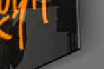 Cartoon-notation artwork anchoring a wall with onyx-and-tangerine palette