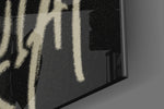 Stencil-and-crown artwork anchoring a wall with chalk-and-onyx palette