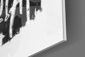 Minimal-silhouette artwork anchoring a wall with onyx-and-chalk palette