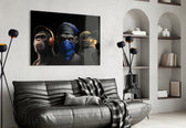3 Wise Monkeys glass wall art styled above a console in a study