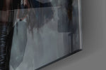Leather-muse artwork anchoring a wall with slate-and-onyx palette