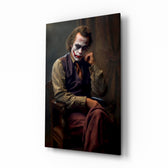 Joker the Thinker glass wall art displayed above a leather chesterfield in a study