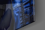 Hooded-muse artwork anchoring a wall with cobalt-and-onyx palette