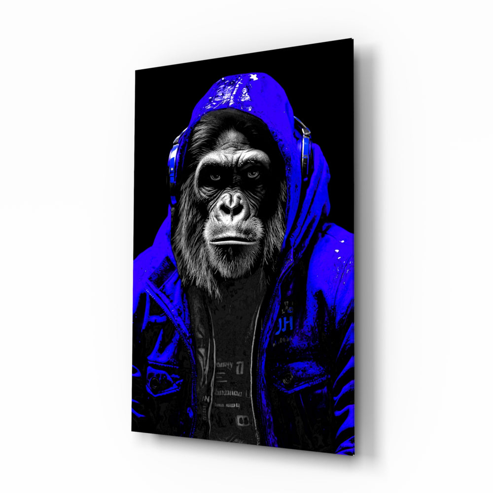 The Ape glass wall art displayed above a leather sofa in a moody man cave