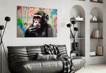Thinking Monkey glass wall art styled above a desk in a creative office