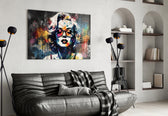 Marilyn Monroe glass wall art styled above a console in a creative office