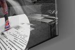 Basketball-legend artwork anchoring a wall with monochrome-and-scarlet palette