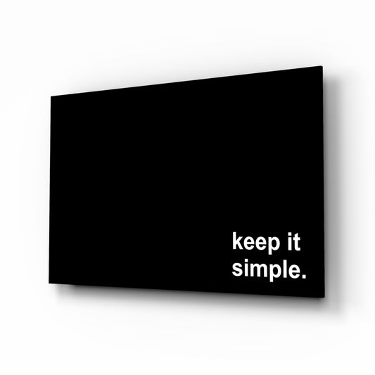 Keep It Simple glass wall art displayed above a desk in a home office