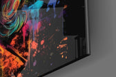 Founding-father artwork anchoring a wall with obsidian-and-spectrum palette