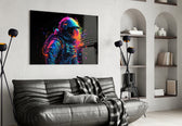 Astronaut glass wall art styled above a sideboard in a creative office