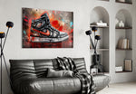 Sneakers glass wall art styled above a sideboard in a media room