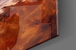Coastal-portrait artwork anchoring a wall with amber-and-cream palette