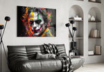Joker glass wall art styled above a sideboard in a media room