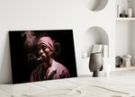 Tupac glass wall art styled above a console in a media room
